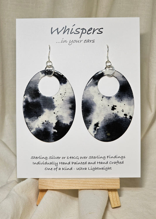 Black n White Cow Hide Print. Hand Painted Paper Earrings. Ultra lightweight, Large statement 2 1/2" Oval. Back is painted to match. Resin coating for durability. Sterling Silver findings. Hangs 2 3/4" in length