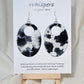 Black n White Cow Hide Print. Hand Painted Paper Earrings. Ultra lightweight, Large statement 2 1/2" Oval. Back is painted to match. Resin coating for durability. Sterling Silver findings. Hangs 2 3/4" in length