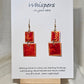 Red n Gold Squared Hand Painted Paper Earrings. 2 Piece dangle red and gold watercolor. Mid size 3/4" and 1" squares. Back is painted to match. Resin coating for durability. 14KG over sterling findings. Hangs 1 7/8" in length