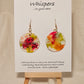 Pink Poppy Trio Hand Painted Paper Earrings. 1 1/2" Circle . Lime green and Hot pink Poppies. Back is painted in complimentary colors. Resin coating for durability. 14KG over sterling silver findings. Hangs 1 3/4" length