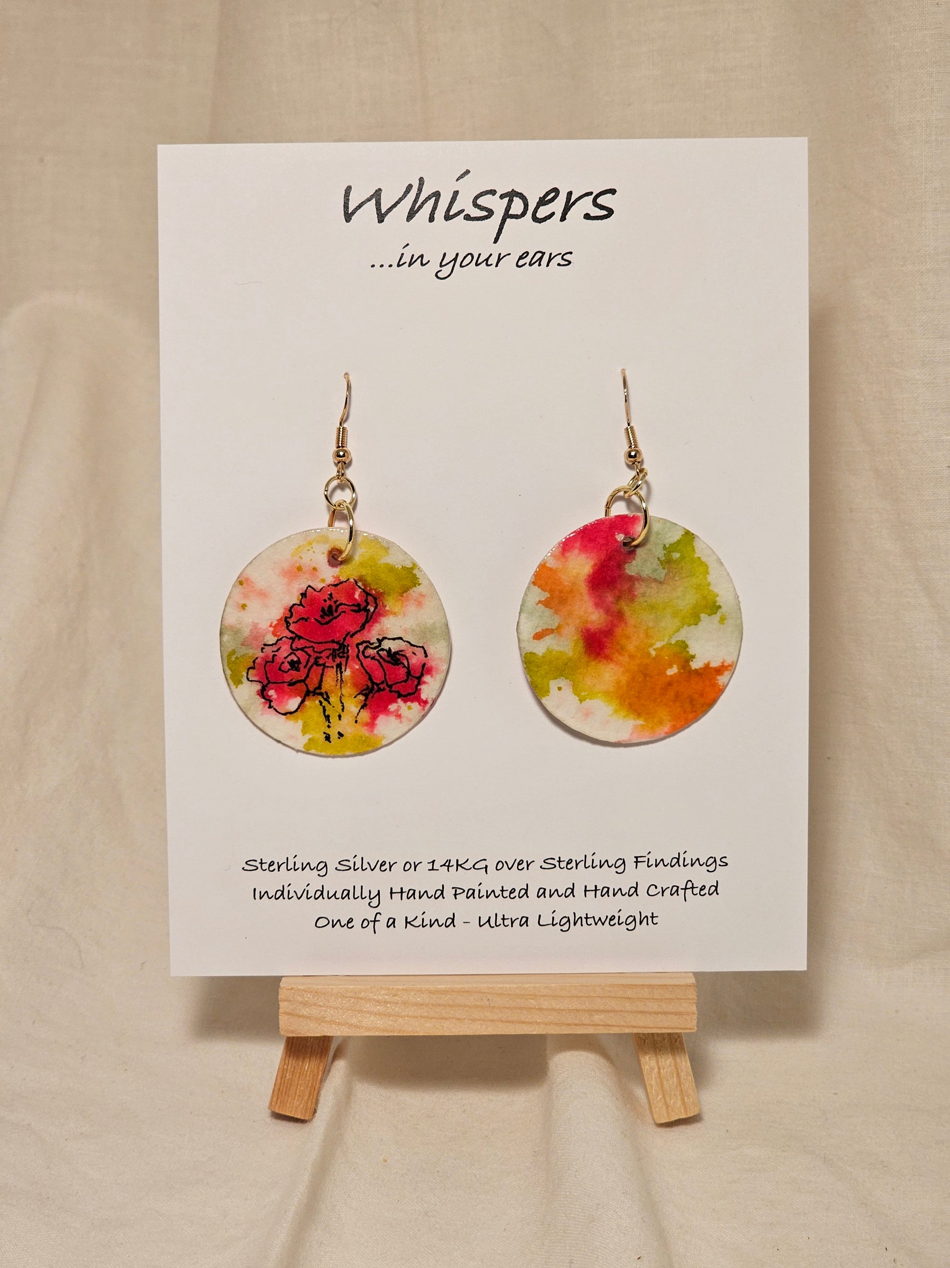 Pink Poppy Trio Hand Painted Paper Earrings. 1 1/2" Circle . Lime green and Hot pink Poppies. Back is painted in complimentary colors. Resin coating for durability. 14KG over sterling silver findings. Hangs 1 3/4" length