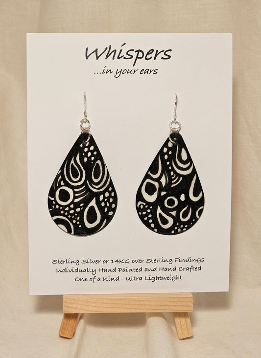 Black n White Swirls n Dots and Painted Paper Earrings. 2 1/8" Tear Drop shape. Abstract white swirls on black background. Back is Grey dots and similar design. Resin coating for durability. Sterling silver findings. Hangs 2 1/2" in length
