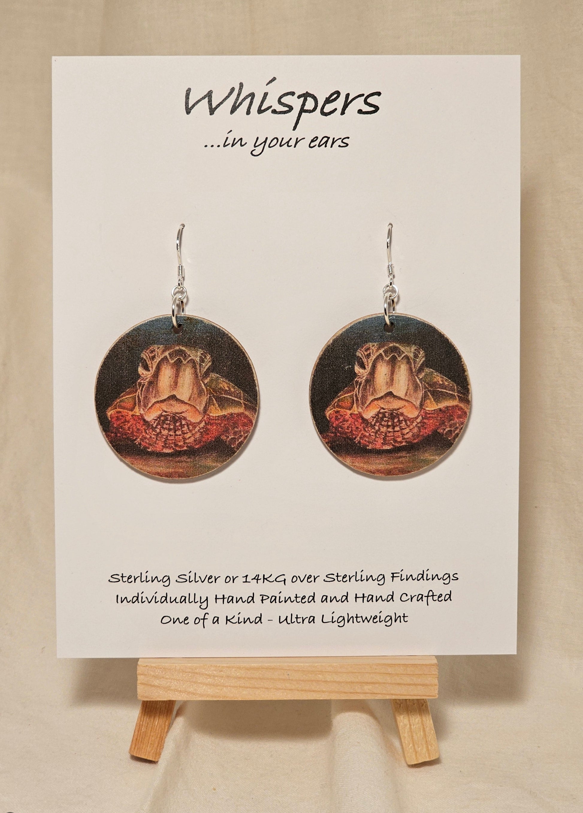 Sea Turtle Art Print Wood Earrings. Art image by Lee M. Hein. Sanded edges beachy look.&nbsp; Back is painted brown wash. 1 1/2" circle. Enameled for durability. Sterling Silver findings. Hangs 1 5/8" in length
