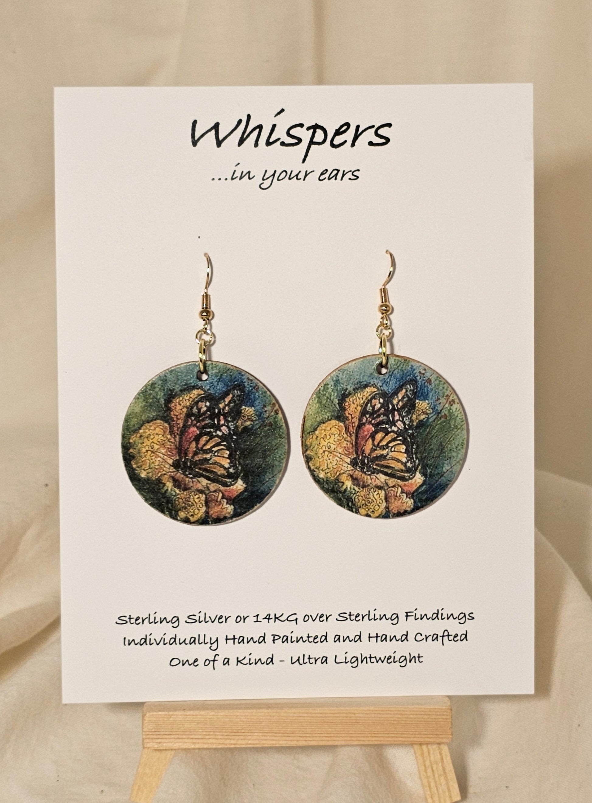 Butterfly Art Print Wood Earrings. Artwork by Lee M. Hein. 1 1/2" Circle. Back is painted brown wash. Enameled for durability. 14KG over Sterling findings. Hangs 1 3/4" in length