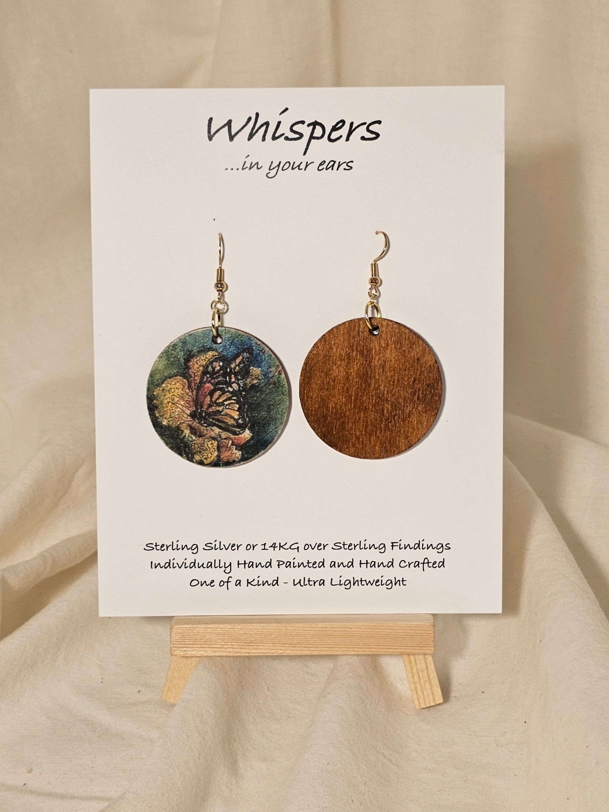 Butterfly Art Print Wood Earrings. Artwork by Lee M. Hein. 1 1/2" Circle. Back is painted brown wash. Enameled for durability. 14KG over Sterling findings.  Hangs 1 3/4" in length