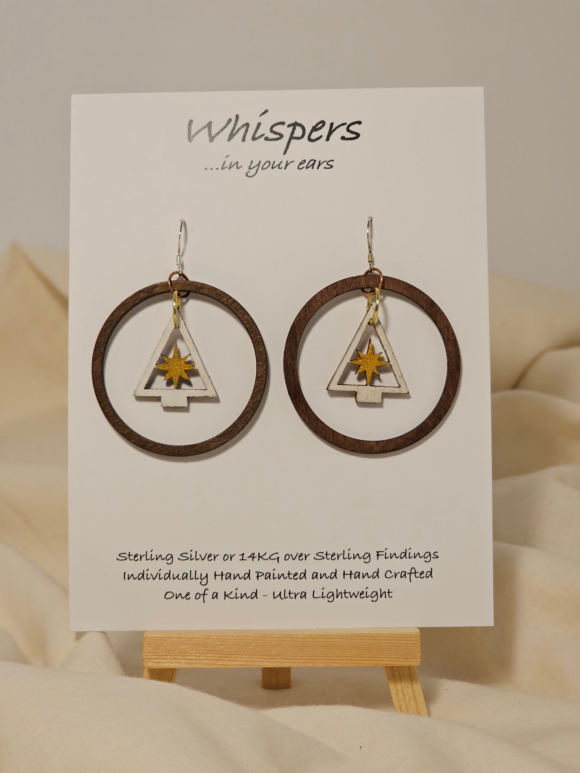 Frosted Gold Star Tree Ring Wood Earrings. Large 1 3/4" Dark wood tone ring with hand painted white tree with gold star pendant hanging in the center. Mixed metal findings. Sterling wires. enameled for durability. Hangs 2" in length