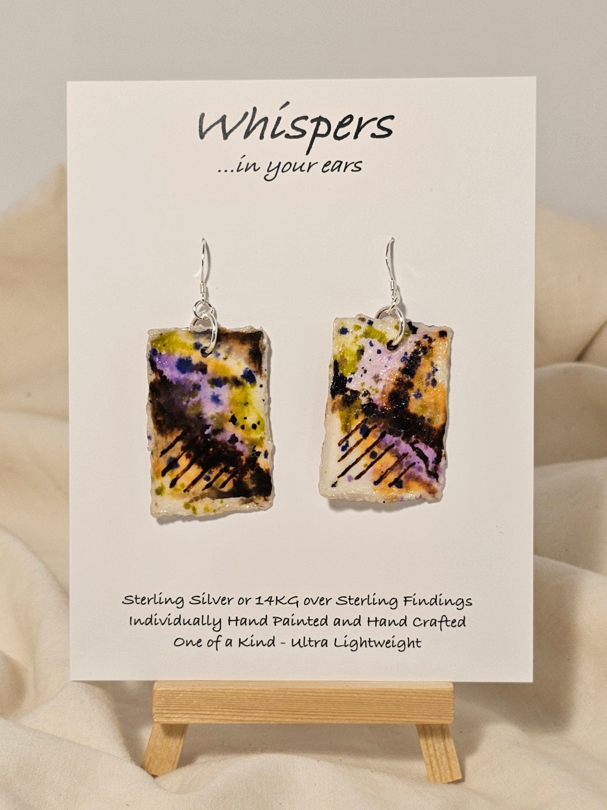 On the Fence Beach Scape Hand Painted Paper Earrings. Colorful abstract beach scape. Back is painted to match. Resin coating for durability. Sterling Silver findings. Hangs1 3/4" in length