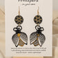 Bee Golden Wood Die Cut Hand Painted Earrings. Honeycomb in gold and black painted wood disc. Metallic painted bee wood die cut. Back is painted to match. Enameled for durability. 14KG over sterling silver findings. Hangs 3" in length