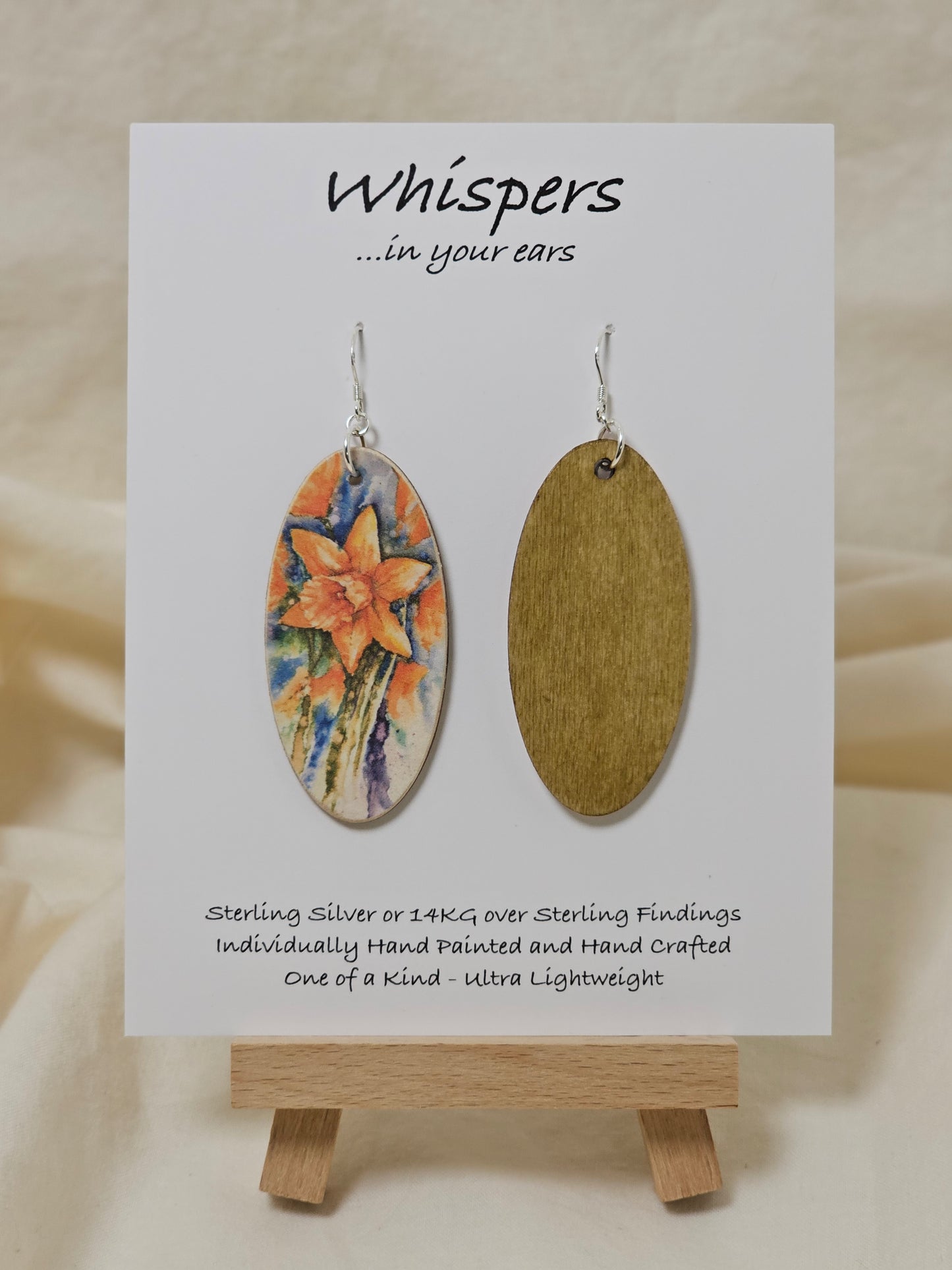 Daffodil Art Print Wood Earrings. Artwork by Lee M. Hein. Elongated wood oval with watercolor print of Daffodil. Back is brown wash. Enameled for durability. Sterling Silver findings Hangs 2 1/4" in length