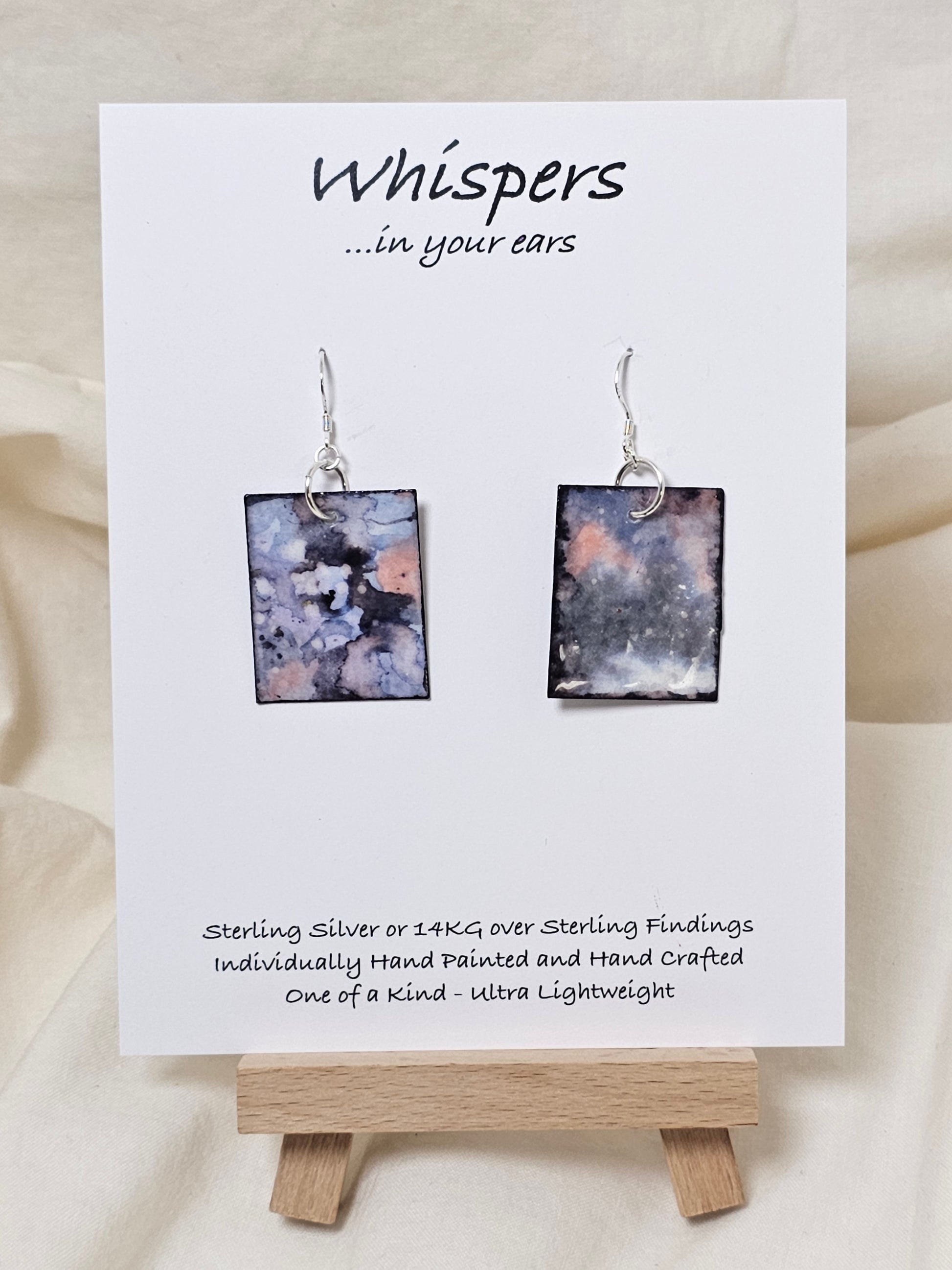 Periwinkle Quartz Hand Painted Paper Earrings. Ultra lightweight 1 1/4" rectangle painted in watercolor. Periwinkle, navy blue and pink faux quartz. Back is painted with complimentary design. Resin coating for durability. Sterling Silver findings. Hangs1 1/2" in length