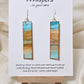 Beachscape Reflection Statement Hand Painted Paper Earrings. Abstract beachscape painted in and on heavy watercolor paper. 1/2" x 2 1/2" elongated rectangle. In muted blues and beiges and corals. Reflection of landscape. Resin coating for durability. Sterling silver ear wires and findings. Ultra lightweight. Hangs 2 3/4"