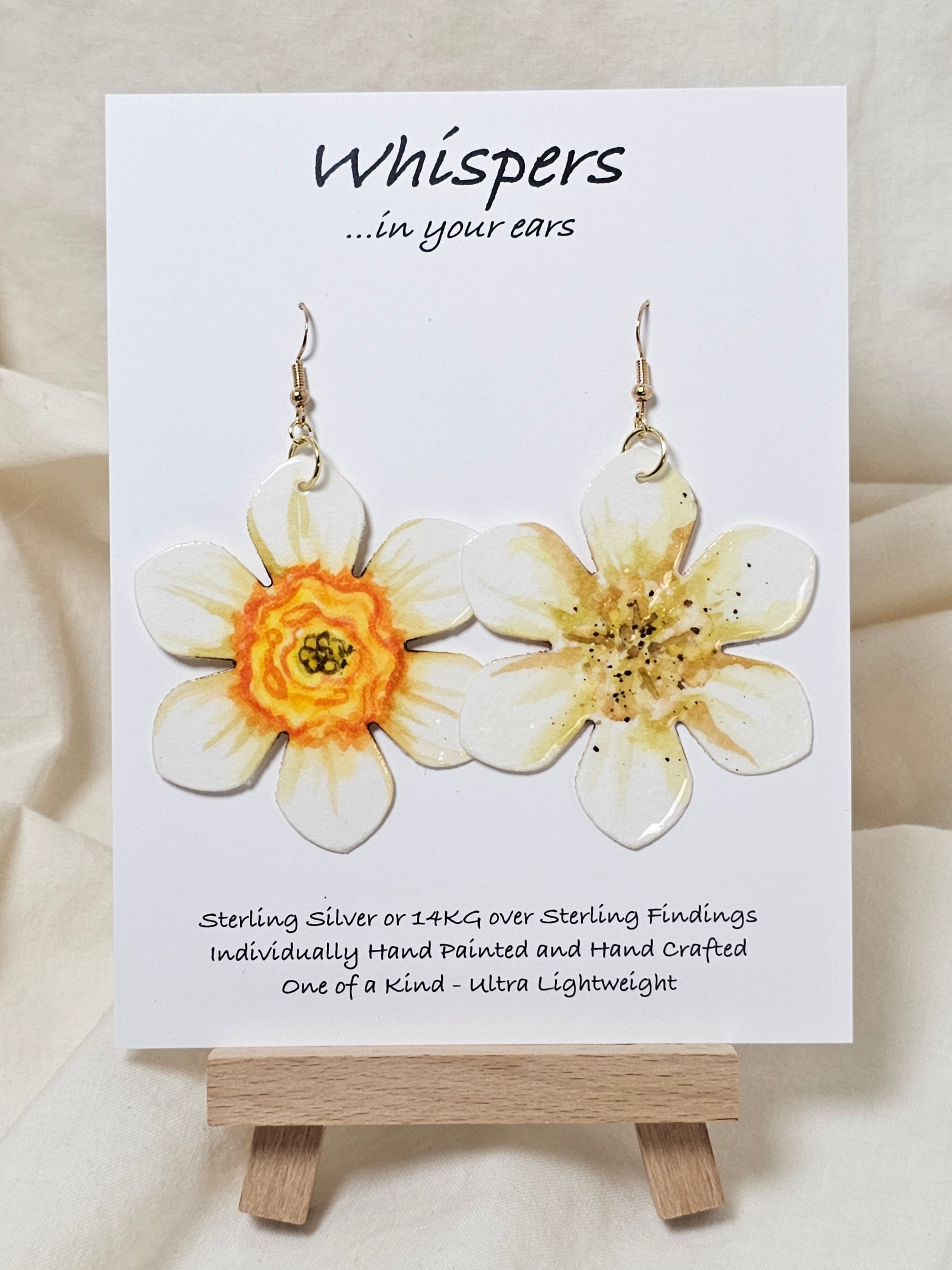 Natural Daffodil Flower Hand Painted Paper Earrings. Ultra lightweight 2 1/2" in diameter. Watercolor painted to resemble a yellow centered white daffodil. Back is painted in complimentary colors. Resin Coating for durability. Mixed metal findings. 14KG over sterling ear wires. Hangs 2 5/8" in length