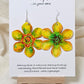 Pop Art Daffodil Flower Hand Painted Paper Earrings. Ultra lightweight 2 1/2" in diameter. Watercolor painted to resemble bright yellow and orange daffodil. Back is painted in complimentary colors. Resin Coating for durability. Sterling Silver findings. Hangs 2 5/8" in length
