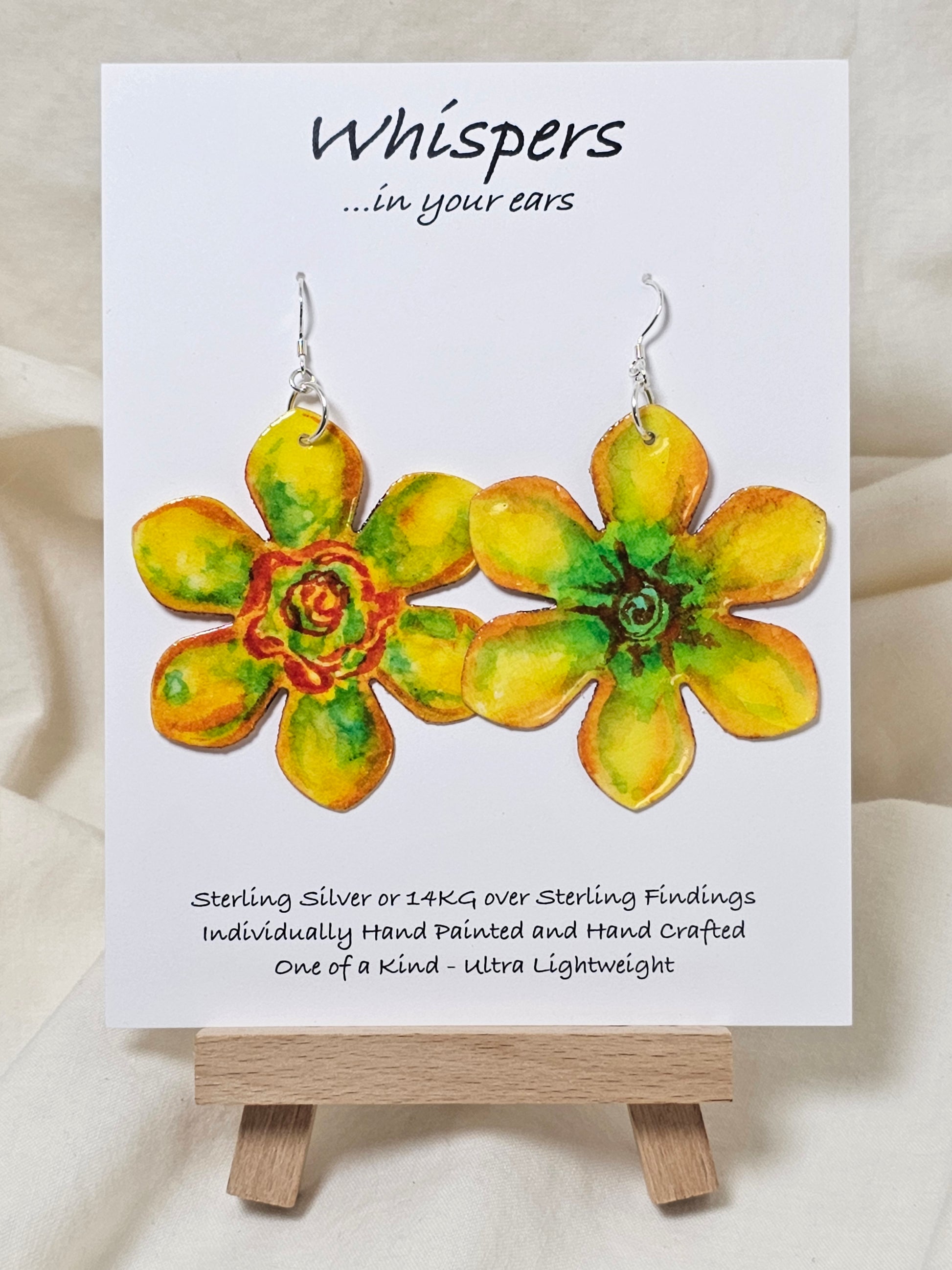 Pop Art Daffodil Flower Hand Painted Paper Earrings. Ultra lightweight 2 1/2" in diameter. Watercolor painted to resemble bright yellow and orange daffodil. Back is painted in complimentary colors. Resin Coating for durability. Sterling Silver findings. Hangs 2 5/8" in length