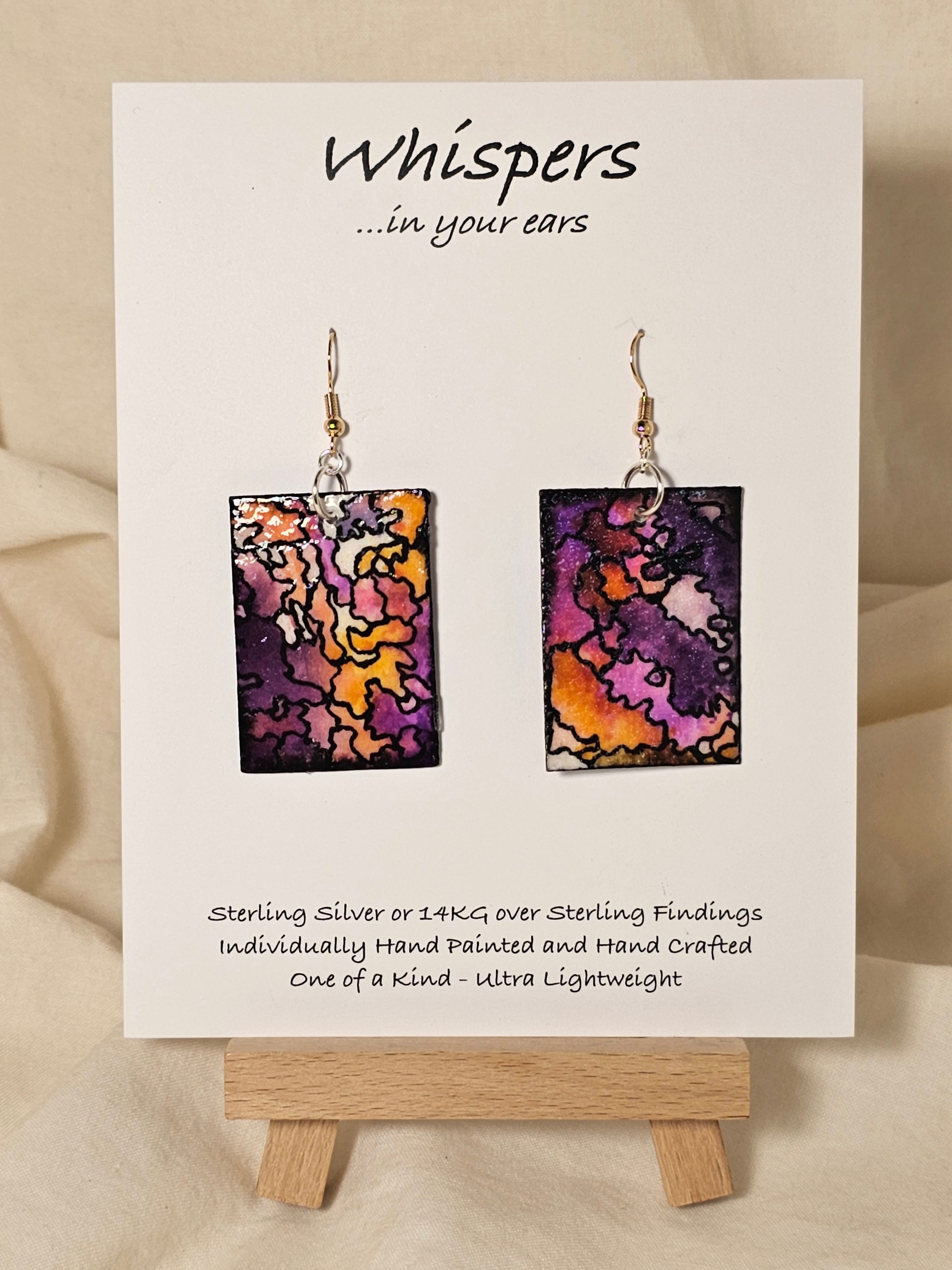 Puzzled Hand Painted Paper Earrings.&nbsp; Ultra lightweight 1 5/8" rectangle painted multicolor puzzle. Back is painted with the same design. Resin coating for durability. Mixed metal findings Sterling silver and 14KG over sterling ear wires. Hangs 1 3/4" in length