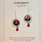 Red Skies Hand Painted Paper and Silver Alloy Earrings. 3/4" Circular watercolor painting of trees and mountains in silhouette against a red sky. Painting hanging in the center of a silver alloy circle. below hangs a red bead embellishment. Back is painted to match. Sterling Silver findings. Resin coating for durability. Hangs 2 1/8" in length