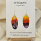 Desert Sunset Hand Painted Paper Earrings.&nbsp; Ultra lightweight 2" Elongated oval. Features Cactus in silhouette. Vibrant orange yellow and purple sky. Painted dark edge. Back is painted with similar color. Resin coating for durability. Sterling Silver findings. Hangs 2 1/8" in length