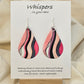Fifties Flare hand painted watercolor ultra lightweight paper earrings. 2" Teardrop shape painted in hot pink and coral pink gem tones. Accented with black and white varied wavy lines. Back is painted with similar colors and design. Resin coating for durability. Sterling silver findings. Hangs 2 1/4" in Length