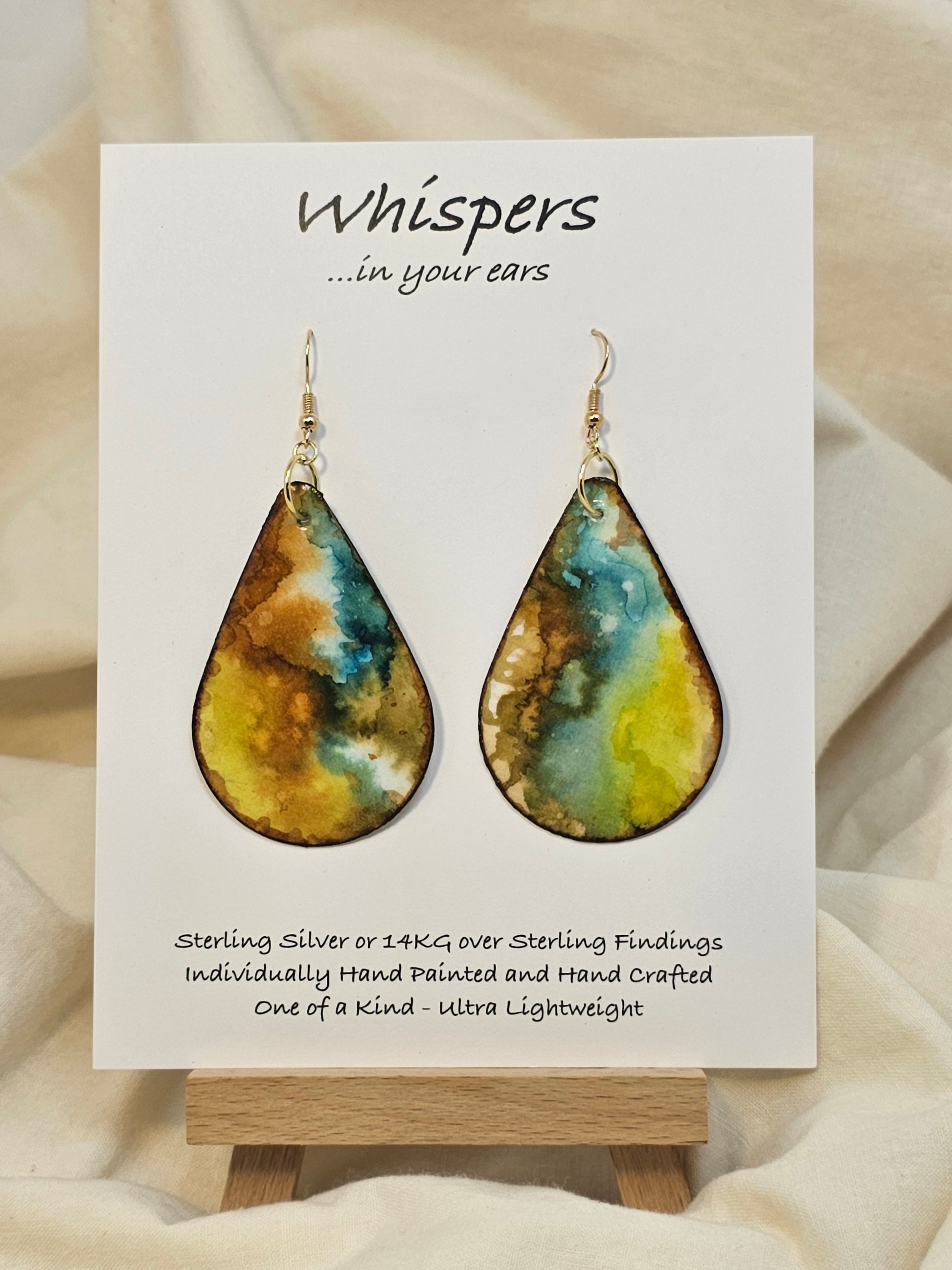 Mossy Agate hand painted watercolor ultra lightweight paper earrings. 2" Teardrop shape painted in Brown, chartreuse, goldenrod and&nbsp; deep teal gem tones. Accented with brown edges. Back is painted with similar colors and design. Resin coating for durability. Sterling silver and 14KG over sterling findings. Hangs 2 3/8" in Length