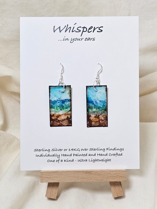 Blowing Ocean Scape Hand Painted Paper Earrings. Ultra lightweight ! 1/2" Rectangle painted in watercolor. Abstract ocean scape. Aqua, blues and browns. Back is painted similar design. Resin coating for durability. Sterling silver findings. Hangs 1 3/4" in length