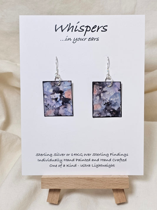 Periwinkle Quartz Hand Painted Paper Earrings. Ultra lightweight 1 1/4" rectangle painted in watercolor. Periwinkle, navy blue and pink faux quartz. Back is painted with complimentary design. Resin coating for durability. Sterling Silver findings. Hangs1 1/2" in length
