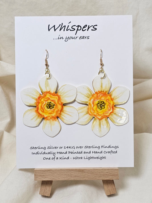 Natural Daffodil Flower Hand Painted Paper Earrings. Ultra lightweight 2 1/2" in diameter. Watercolor painted to resemble a yellow centered white daffodil. Back is painted in complimentary colors. Resin Coating for durability. Mixed metal findings. 14KG over sterling ear wires. Hangs 2 5/8" in length