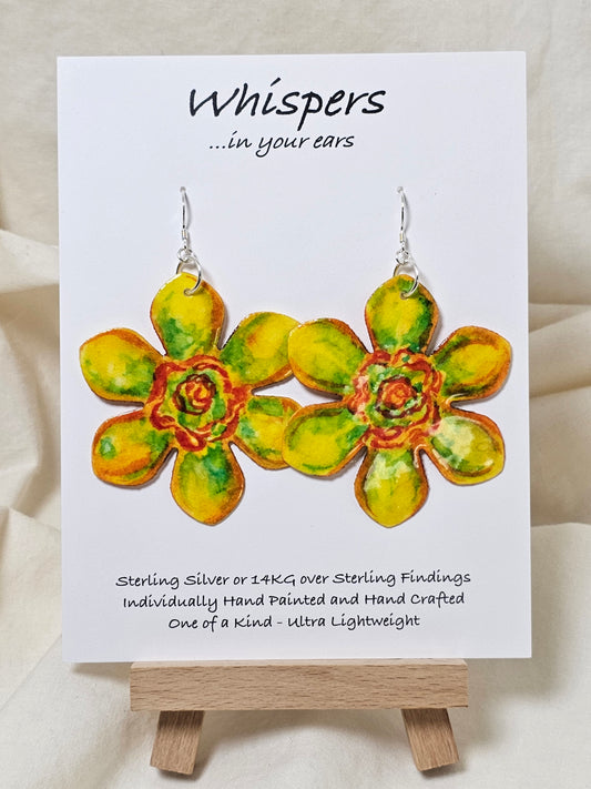 Pop Art Daffodil Flower Hand Painted Paper Earrings. Ultra lightweight 2 1/2" in diameter. Watercolor painted to resemble bright yellow and orange daffodil. Back is painted in complimentary colors. Resin Coating for durability. Sterling Silver findings. Hangs 2 5/8" in length