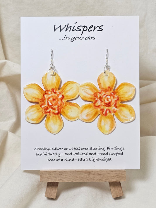 Tangerine Daffodil Flower Hand Painted Paper Earrings. Ultra lightweight 2 1/2" in diameter. Watercolor painted to resemble bright yellow and orange daffodil. Back is painted in complimentary colors. Resin Coating for durability. Sterling Silver findings. Hangs 2 5/8" in length