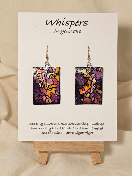 Puzzled Hand Painted Paper Earrings.&nbsp; Ultra lightweight 1 5/8" rectangle painted multicolor puzzle. Back is painted with the same design. Resin coating for durability. Mixed metal findings Sterling silver and 14KG over sterling ear wires. Hangs 1 3/4" in length