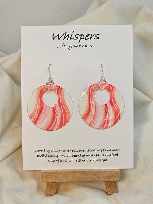 Sweet Swirls Hand painted watercolor paper earrings. Ultra lightweight. Dark pink, light pink, peach and white wavy stripes over a white background. Back is painted with similar color and design. Large circular in shape with circular cut out. Resin coating for durability. Sterling silver findings. Hangs 2" in Length