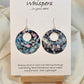 Bubbles Hand painted watercolor paper earrings. Ultra lightweight. Dark blue, pink, light pink, turquoise with white circles . Back is painted with similar color and design. Large circular in shape with circular cut out. Resin coating for durability. Sterling silver findings. Hangs 2" in Length