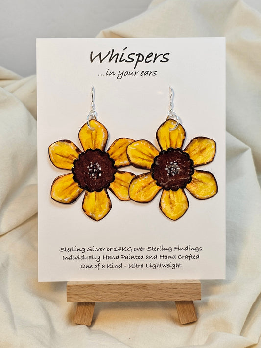 Sunflower Layered Flower Hand Painted Paper Earrings. Ultra lightweight 2 1/2" in diameter. Watercolor painted to resemble bright yellow sunflower. Center is separate layer painted dark brown. Back is painted in complimentary colors with small petal detail layer. Resin coating for durability. Sterling Silver findings. Hangs 2 5/8" in length