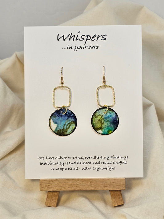 Earth Drop Gold Alloy Rectangle with Hand Painted Paper Earrings. 1" Circular painting in Aqua blue, brown, black and lime green. Hanging from the Gold alloy. Back is painted to match. Ultra lightweight. Resin coating for durability. 14KG over sterling findings. Hangs 1 3/4" in length