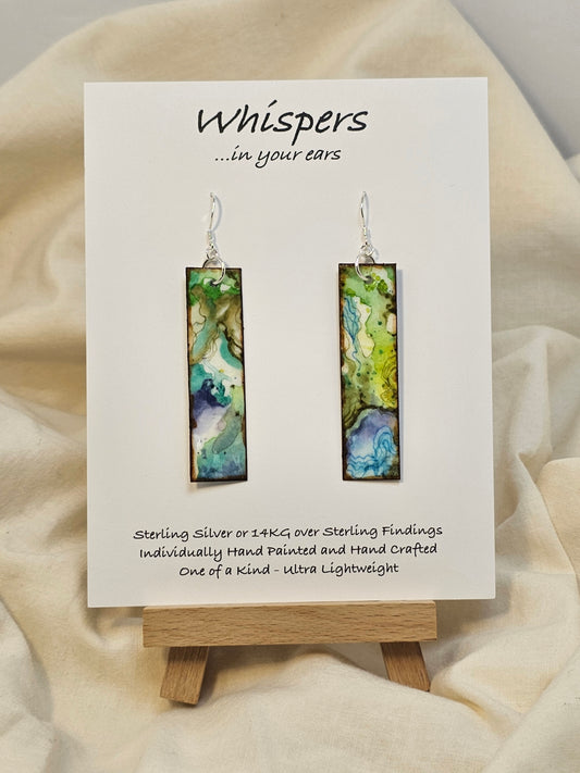 Turquoise Waters Hand Painted Watercolor Paper Earrings. Ultra lightweight, 1/2" x 2 1/4" Rectangle painted in watercolor abstract aerial view of turquoise blue waters and green land. Back is complimentary colors and design. Edged in brown paint. Resin coating for durability. Sterling silver findings. Hangs 2 1/2" in length