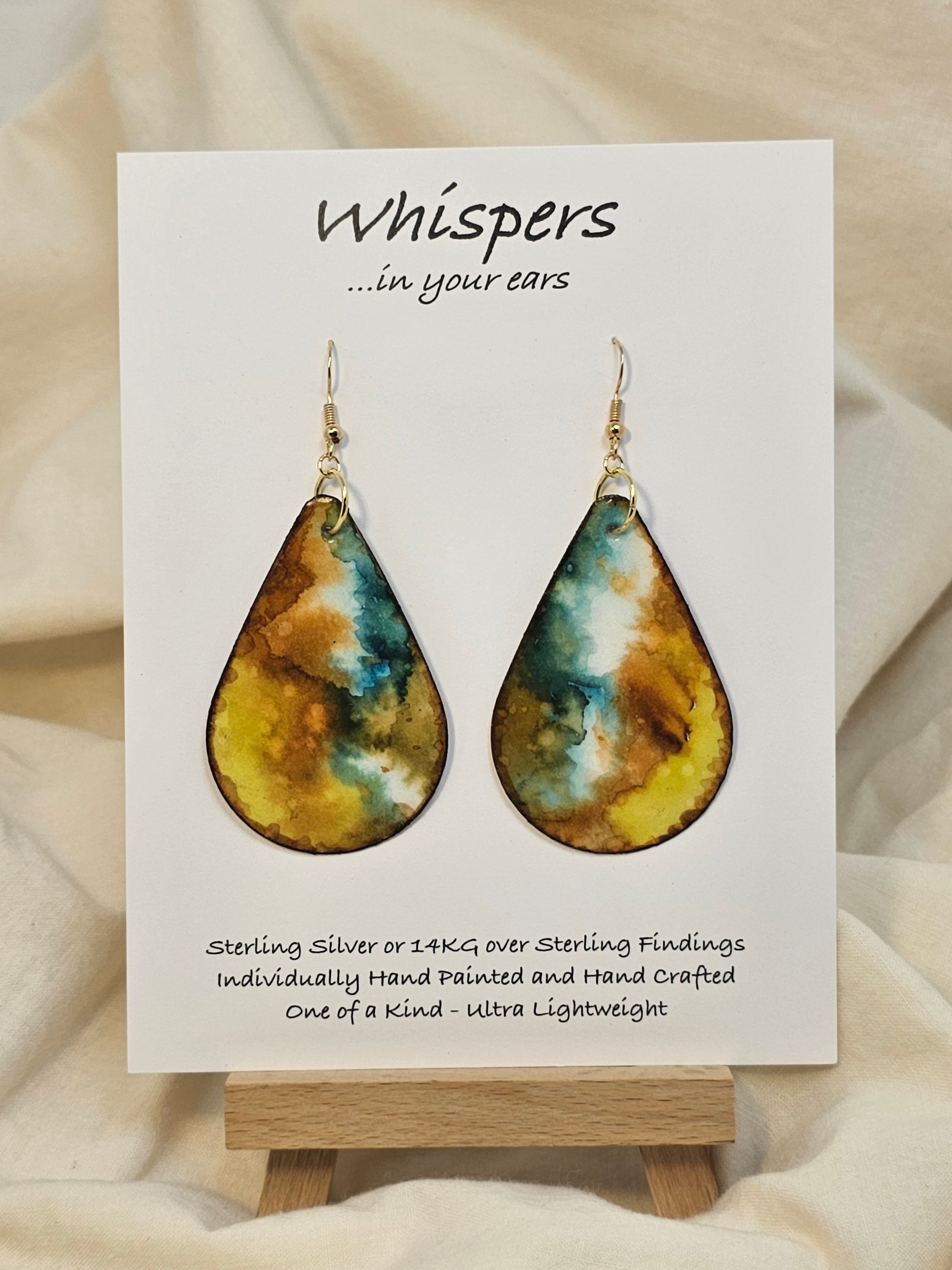 Mossy Agate hand painted watercolor ultra lightweight paper earrings. 2" Teardrop shape painted in Brown, chartreuse, goldenrod and&nbsp; deep teal gem tones. Accented with brown edges. Back is painted with similar colors and design. Resin coating for durability. Sterling silver and 14KG over sterling findings. Hangs 2 3/8" in Length