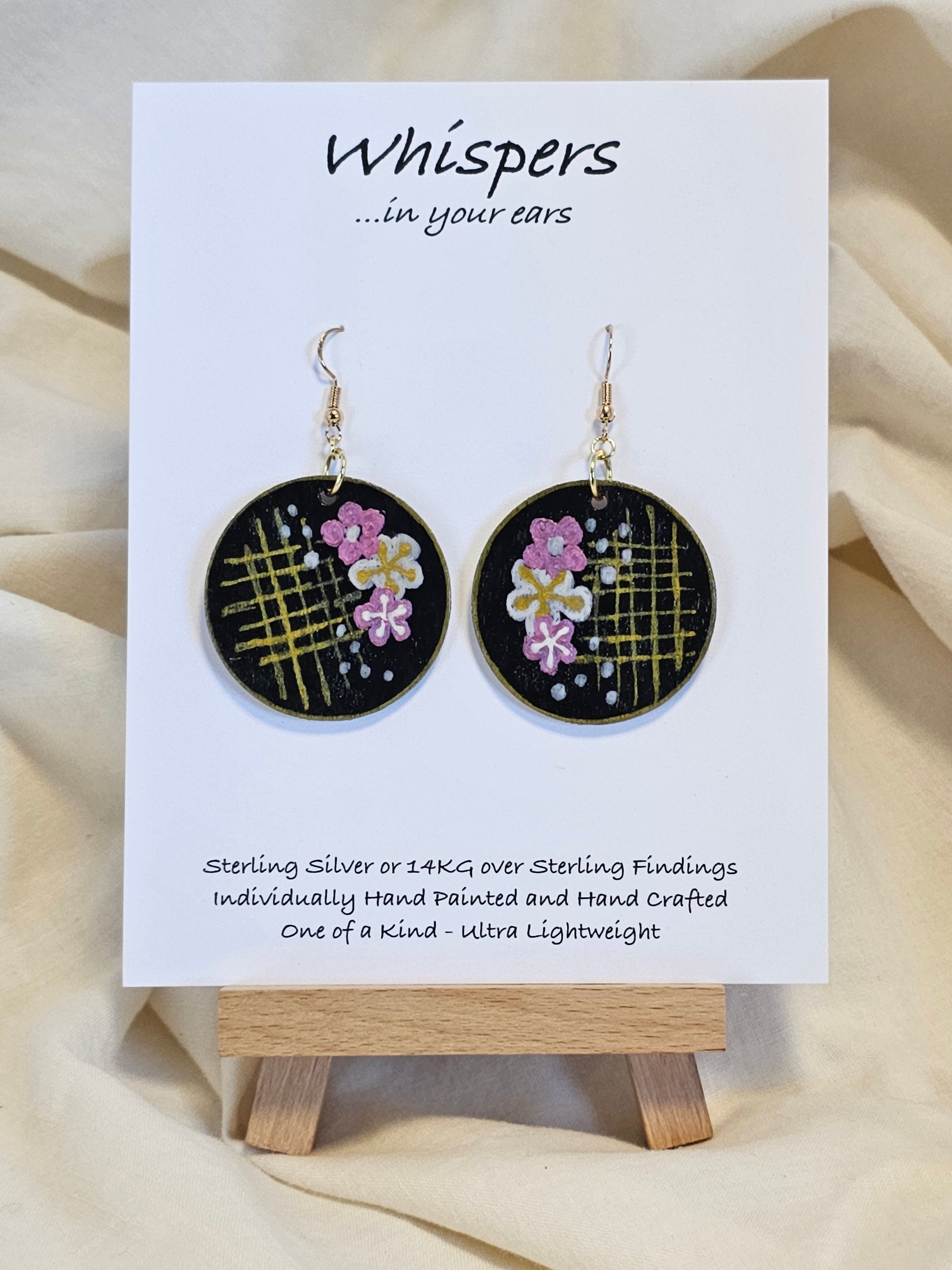 Cherry Blossom Grid Hand Painted/Crafted Wood Earrings. 1 1/2" Wood Disc with handmade paper with painted cherry blossoms painted gold edges. Resin Coating for durability. Back is done to compliment. 14kg over sterling ear wire sterling silver findings. Hangs 1 3/4"
