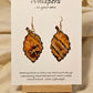 Golden Dragonfly Leaf Hand Painted Paper Earrings. Ultra light weight. 2" Leaf shape. Painted in rust and muted red tones with Golden paper dragonfly atop. Outlined in Dark brown. Back is painted in similar design. 14kg over Sterling Silver ear wires and findings. Resin coating for durability. Hangs 2"