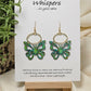 Aqua and Lime Butterfly Hand Painted Wood Earrings. 1"x 1 1/2" Die cut butterfly painted in greens and blues with gold edge accents. Back of butterfly painted in similar design. Hangs gently from gold alloy oval. Hangs 1 5/8". Enameled for durability. 14kg over sterling silver ear wires and findings. Ultra light weight