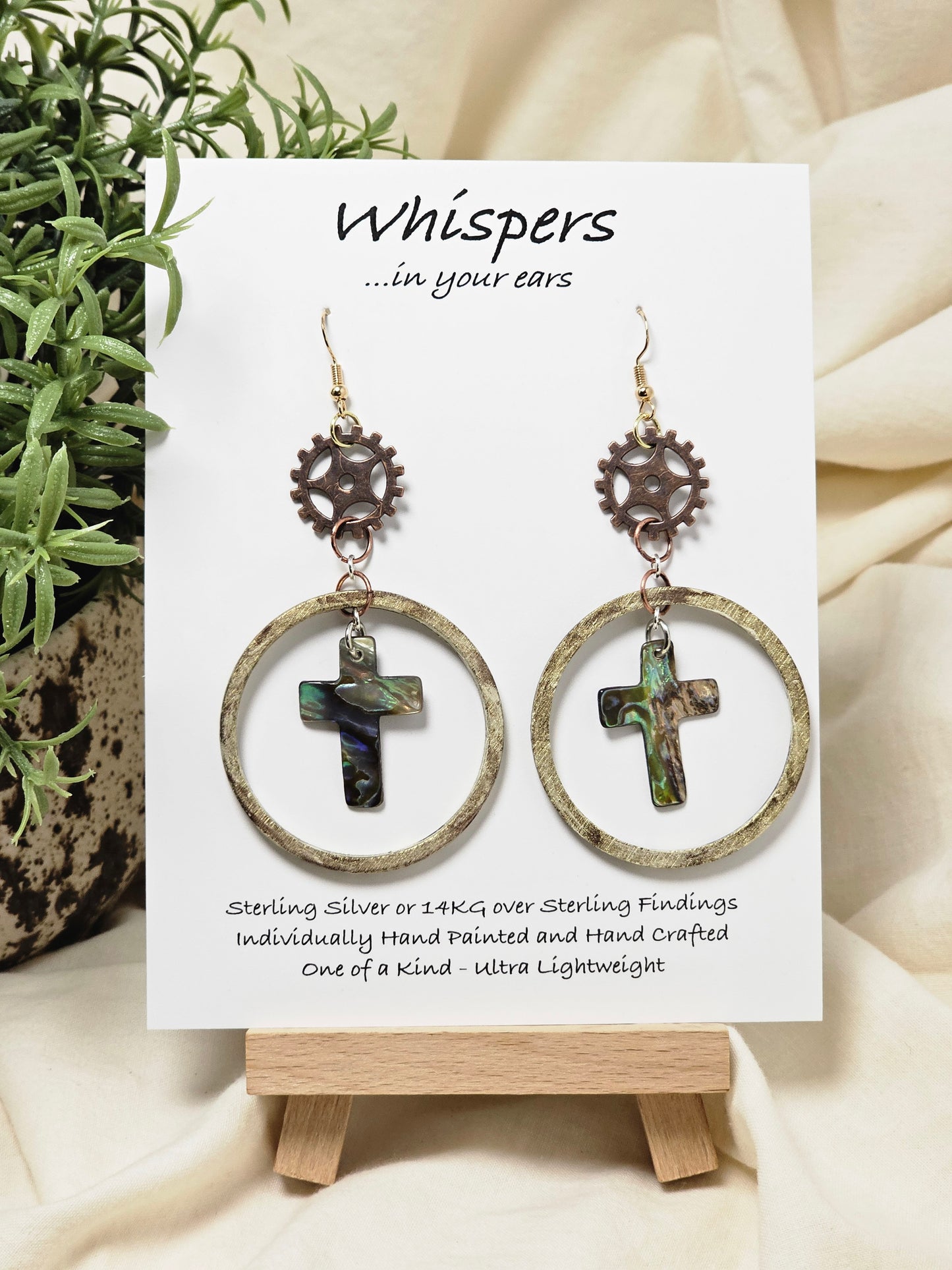 Bronze and Abalone Cross Hand Painted/Crafted Earrings. These gorgeous one of a kind Statement earrings are 14kg Ear wires mixed metal findings. Brass watch gears adorn hand distressed wood circle with abalone crosses. Enameled for durability. Hangs 2 3/4"Ultra light weight