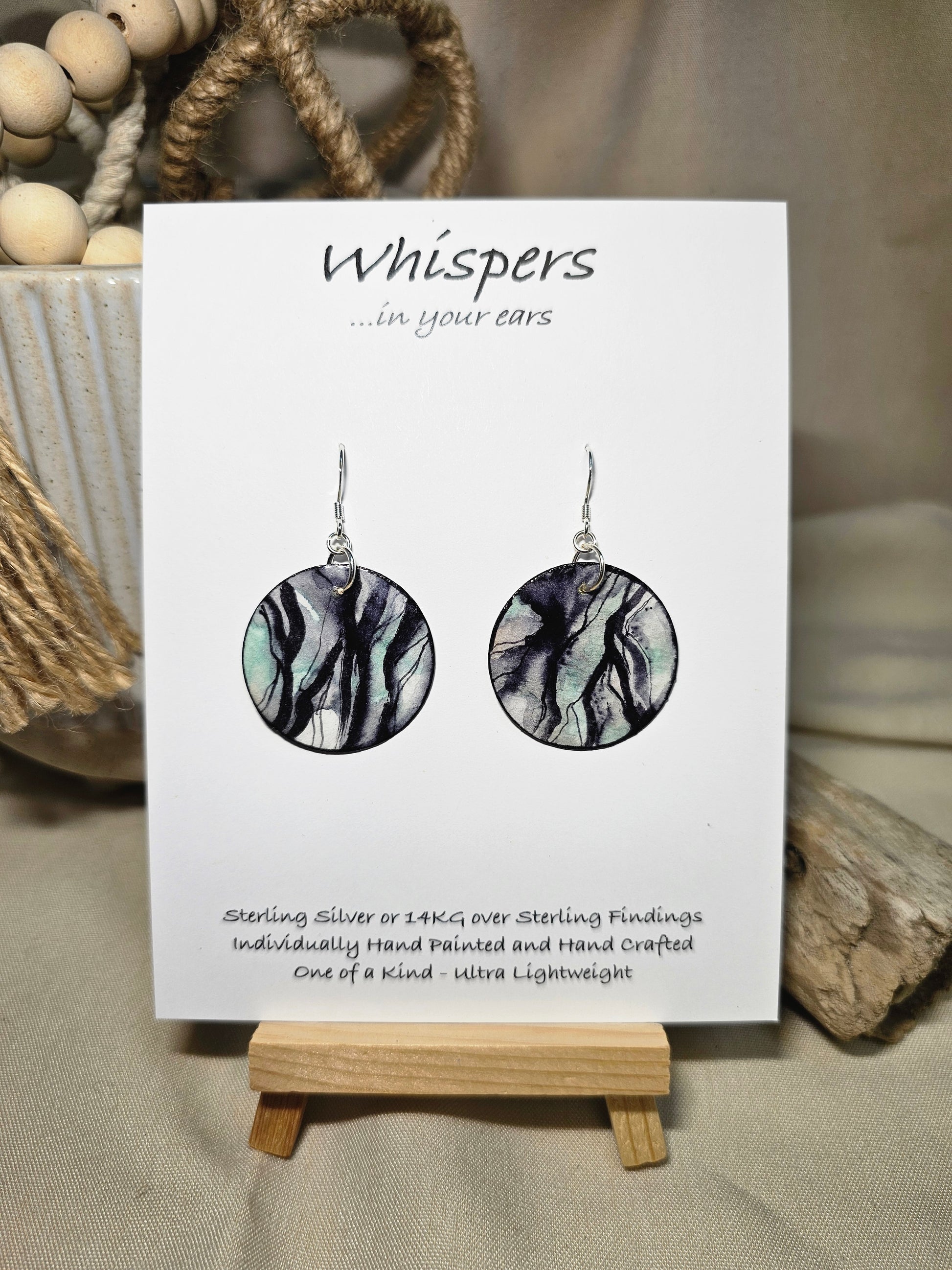 Roots Nature Inspired Hand Painted Paper Earrings. Ultra lightweight 1 1/4" Circle. Black washed roots a top a blue grey washed background. Back is painted in complimentary colors and design. Resin coating for durability. Sterling silver ear wires and findings. Hangs 1 1/2" length