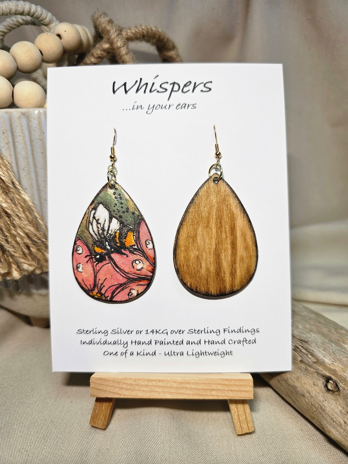 Bee-U-tiful Art Print Wood Earrings. Artwork by Lee M. Hein. 2" Tear drop. Watercolor image of Bumble Bee on a pink flower in tree. Back is painted with light brown wash. Enameled for durability. 14kg over Sterling silver findings. Hangs 2 1/4" in length
