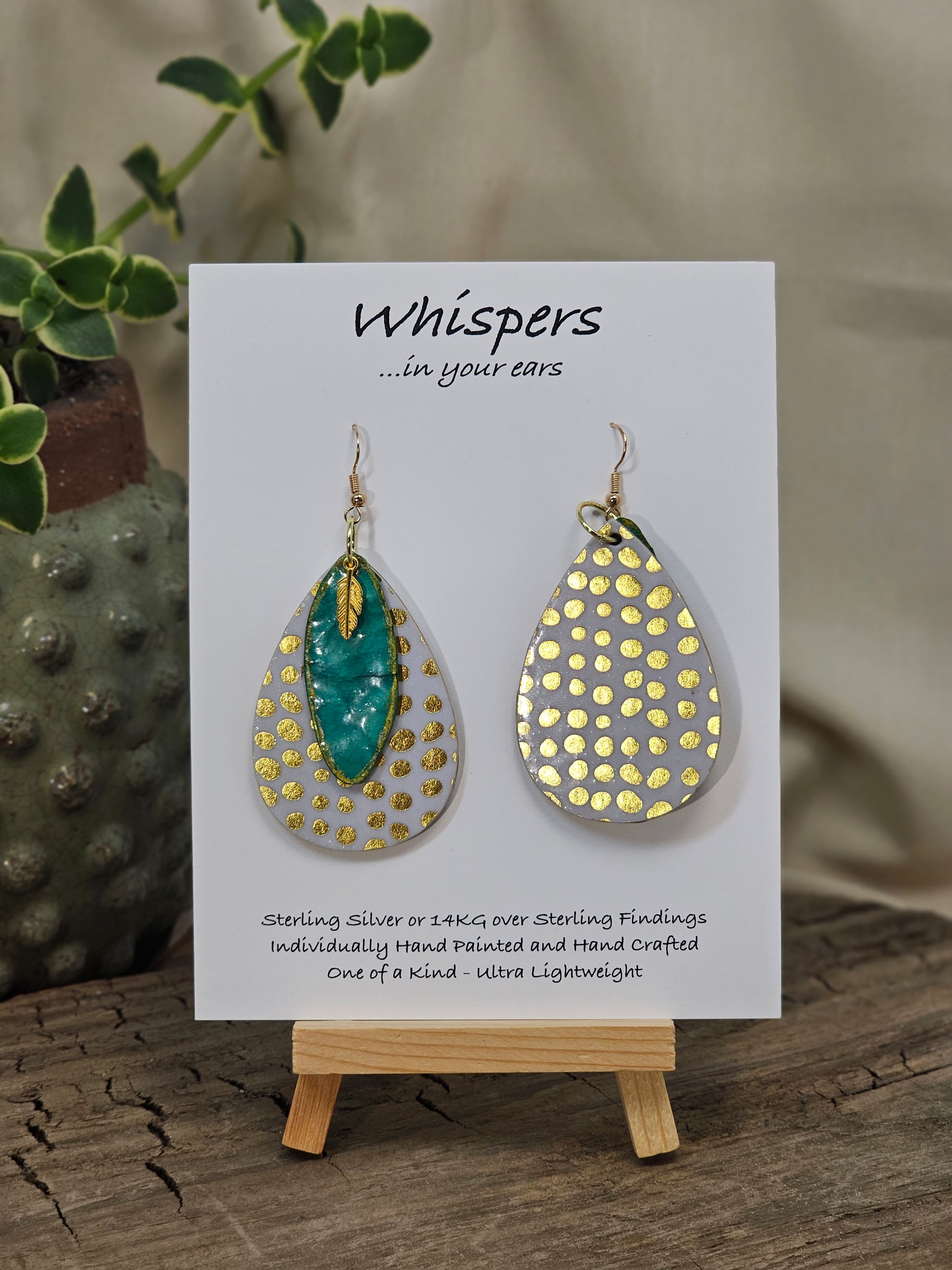 Golden Dots paper over wood 2" Ultra light weight Tear drop earring. This design is on both sides. Hanging hand painted gold edged teal artisan paper pendant. Then gold metal feather charm hangs in front. Enameled for durability. 14kg over Sterling silver findings. Hangs 2 1/4" in length