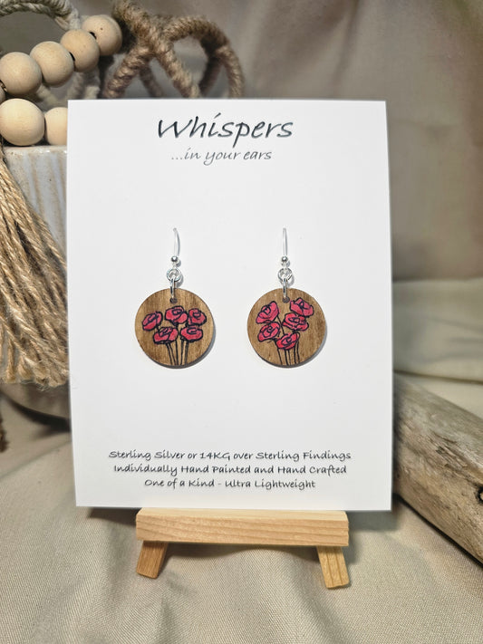 5 Poppies Hand Painted Wood Earrings Stained. 1" wood round, painted with pinkish red bunch of poppies. Ultra light weight. Back of earring is painted in same design. Enameled for durability. Acrylic ear wires, for metal sensitive ear lobes. Hangs 1 1/4"