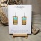 Beach Impressions Hand Painted Paper Earrings. Ultra lightweight 3/4" x 1 1/2" rectangle painted with watercolor. Depicts impressionistic beachscape. Subtle ocean color accents. Edges painted in brown to frame the scene. Back is painted with the same design. Resin coating for durability. Sterling silver ear wires. Hangs 1 3/4" in length