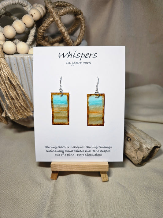 Beach Impressions Hand Painted Paper Earrings. Ultra lightweight 3/4" x 1 1/2" rectangle painted with watercolor. Depicts impressionistic beachscape. Subtle ocean color accents. Edges painted in brown to frame the scene. Back is painted with the same design. Resin coating for durability. Sterling silver ear wires. Hangs 1 3/4" in length