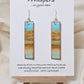 Beachscape Reflection Statement Hand Painted Paper Earrings. Abstract beachscape painted in and on heavy watercolor paper. 1/2" x 2 1/2" elongated rectangle. In muted blues and beiges and corals. Reflection of landscape. Resin coating for durability. Sterling silver ear wires and findings. Ultra lightweight. Hangs 2 3/4"