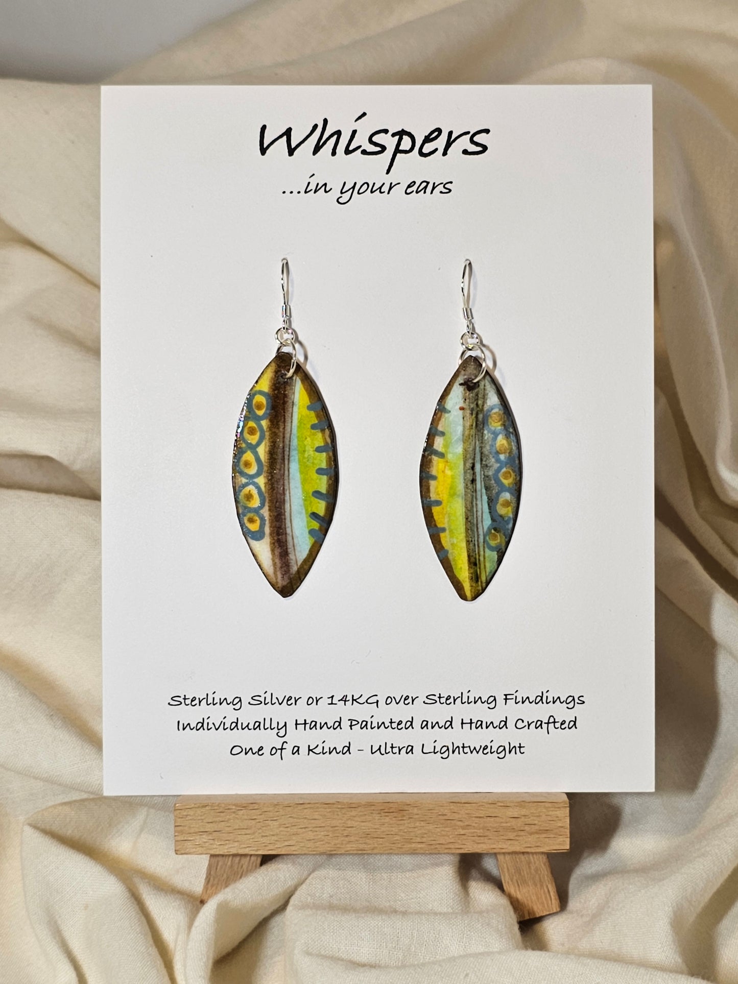 Boho Feather Hand Painted Paper Earrings. Multi colored blues, yellows and brows. Original designs on both sides. Resin coated for durability. Ultra lightweight. Sterling silver ear wires and findings. Hangs 1 3/4"