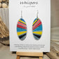 Colorful Retro Sunburst Hand Painted Wood Earrings. Multicolored geometric sunburst painted in acrylics. Back is painted in similar colors and pattern. Enameled for durability. 2" Elongated wood oval. Sterling silver mixed metals with sterling silver findings and hangs 2 1/4" in length