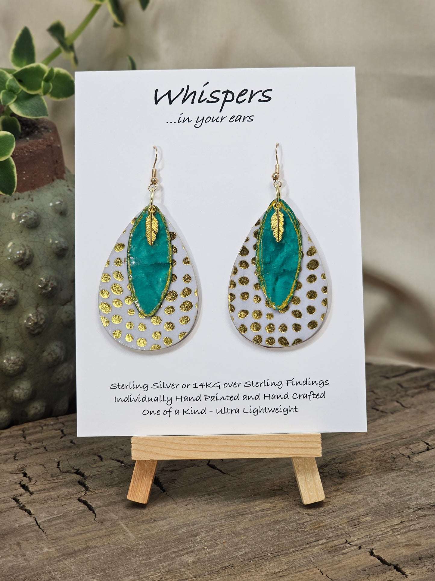 Golden Dots paper over wood 2" Ultra light weight Tear drop earring. This design is on both sides. Hanging hand painted gold edged teal artisan paper pendant. Then gold metal feather charm hangs in front. Enameled for durability. 14kg over Sterling silver findings. Hangs 2 1/4" in length