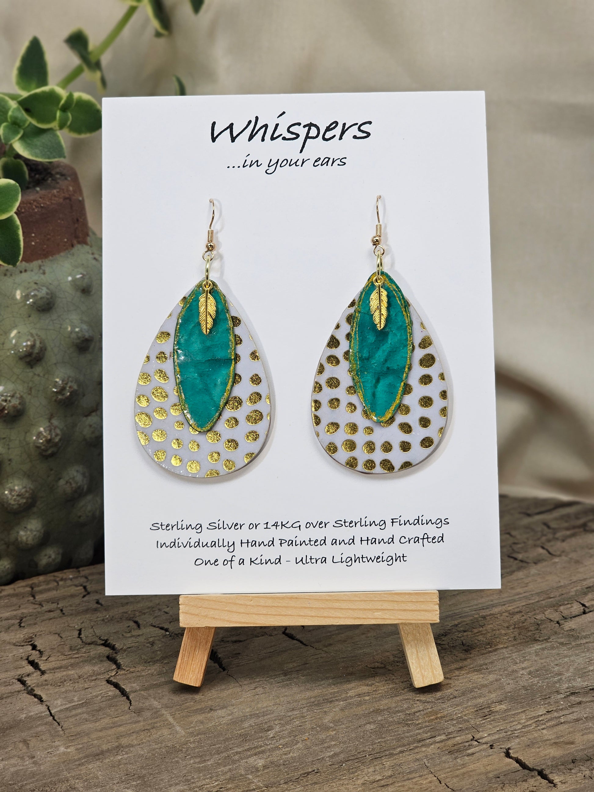 Golden Dots paper over wood 2" Ultra light weight Tear drop earring. This design is on both sides. Hanging hand painted gold edged teal artisan paper pendant. Then gold metal feather charm hangs in front. Enameled for durability. 14kg over Sterling silver findings. Hangs 2 1/4" in length